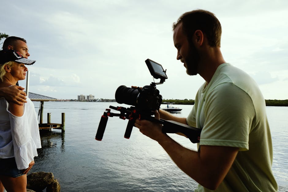Wedding videographer filming a couple outdoors